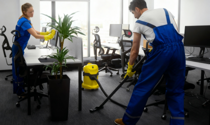 Cleaner Dallas office cleaning team vacuuming carpets and wiping desks in modern workspace