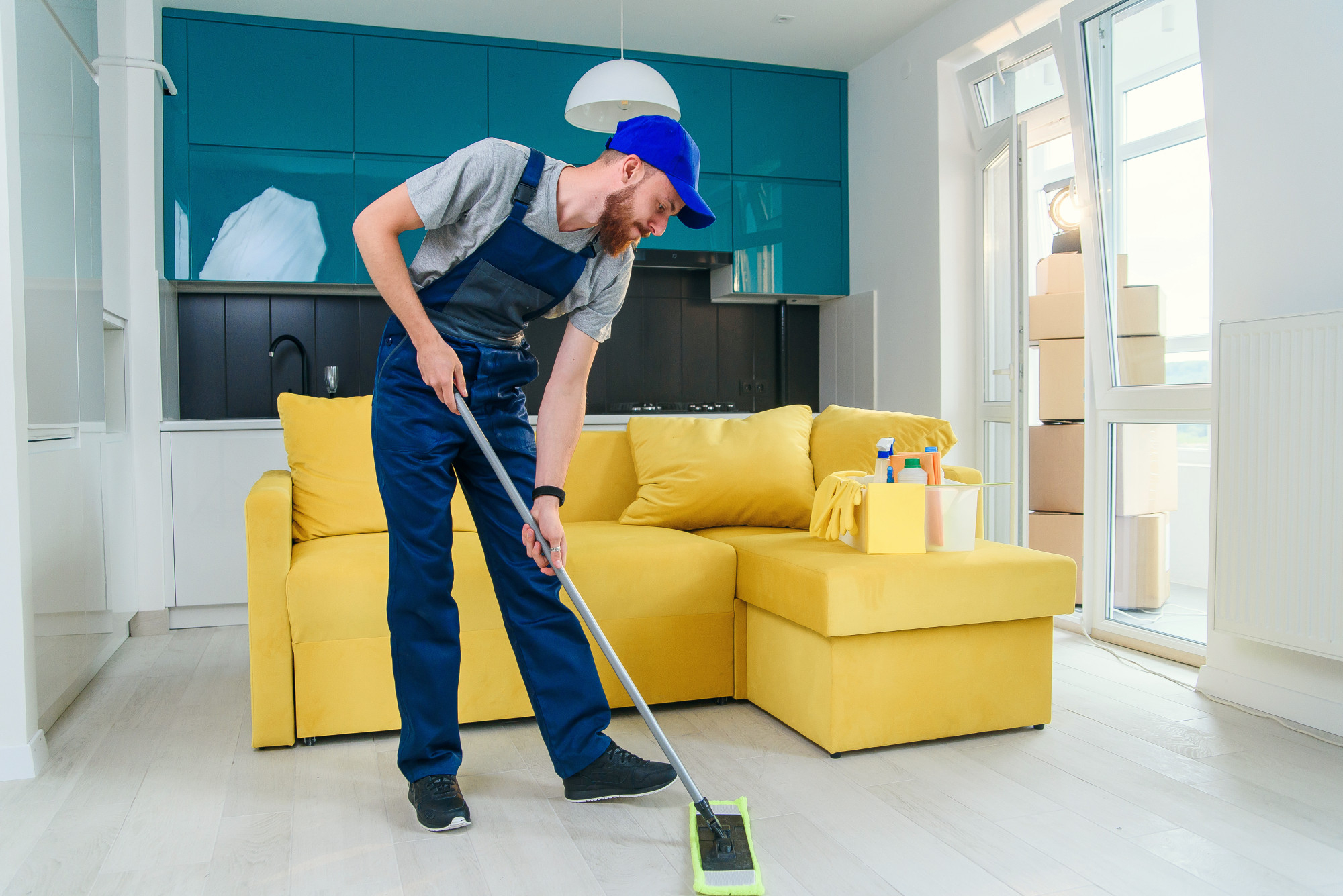 Cleaner Dallas professional cleaner mopping living room floor in bright modern apartment