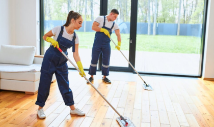 Cleaner Dallas team mopping hardwood floors during professional home cleaning service.