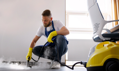 Cleaner Dallas professional cleaner steam cleaning floor for deep sanitation.