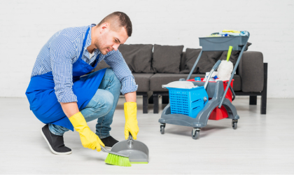 Professional cleaner sweeping floor during move-in move-out cleaning service in Dallas.