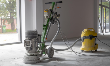 Industrial floor cleaning machine and vacuum used for post-construction cleanup in an unfinished building
